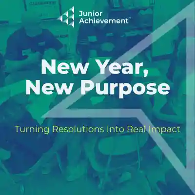 female volunteer in a classroom setting holding flashcard with two ice cream cones, children attentively looking with one student hold their hand up